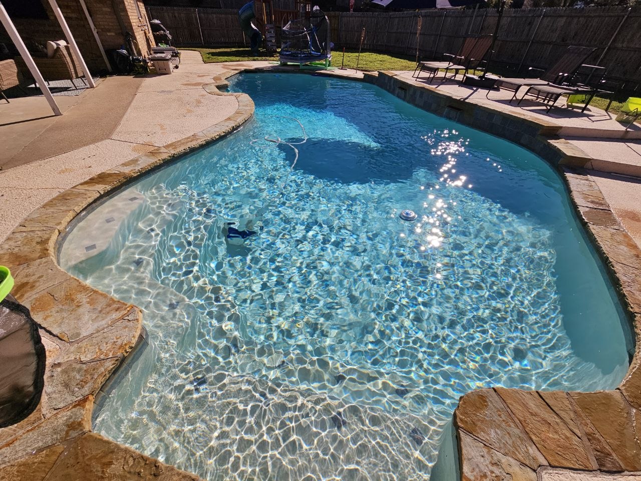 Cartridge pool filter being cleaned during routine maintenance